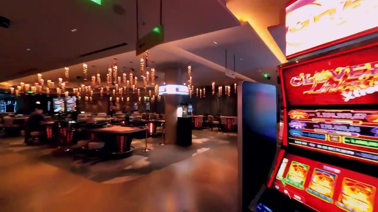 Gaming tables under chandeliers on the casino floor